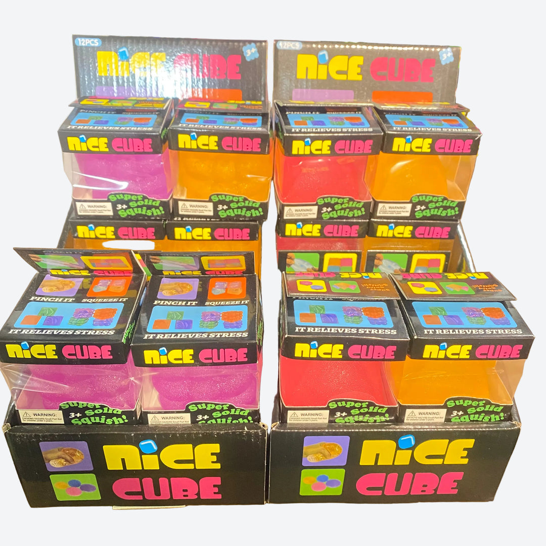 A retail display of 'Nice Cube' stress-relief squeeze balls in various colors, including pink, orange, yellow, and red, packaged in black boxes with colorful branding.