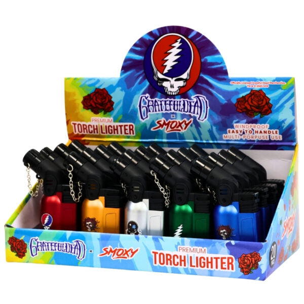Display of Smoxy torch lighters with Grateful Dead branding on packaging.
