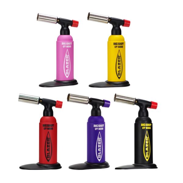 Five torch lighters in different body colors (pink, yellow, red, purple, and black) arranged in two rows on a plain white background. Each lighter has a black base and head with a red ignition button.