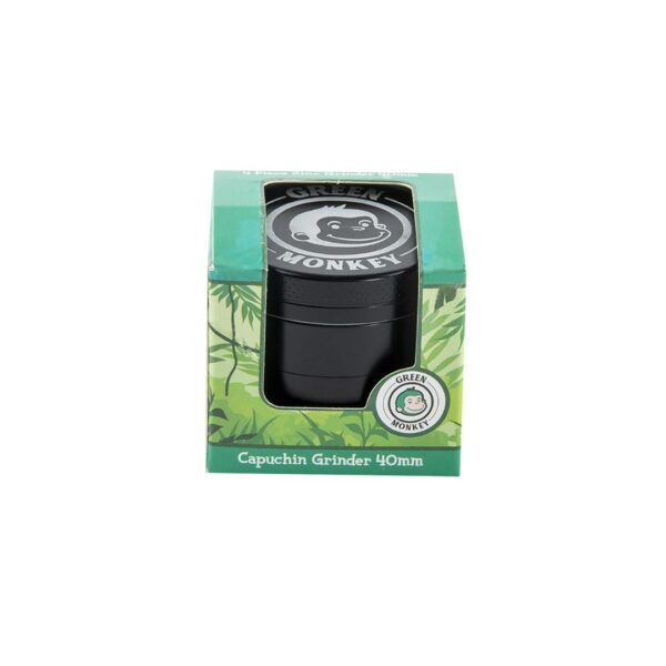 Green Monkey brand 40mm capuchin grinder in its original green packaging box, featuring a clear window showing the black cylindrical grinder inside.