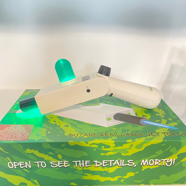 Off-white Hemper Portal Gun jet torch with a glowing green LED dome, resting on its branded green and yellow display box.