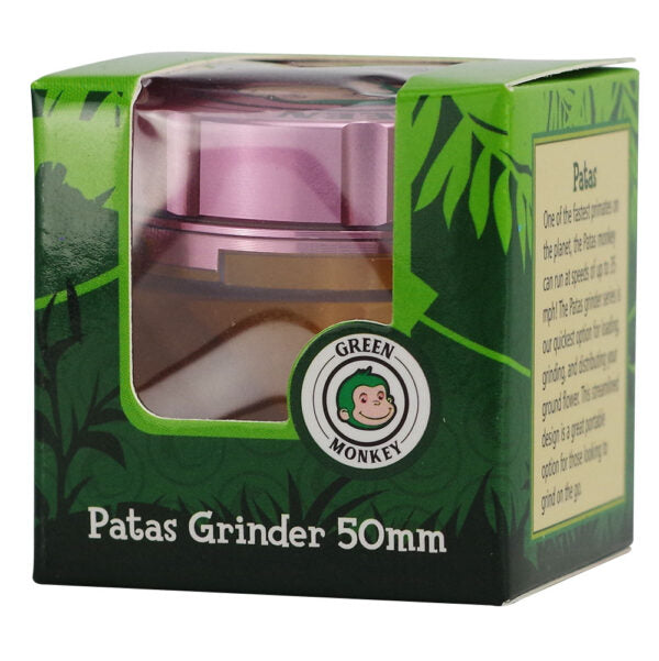 Patas Grinder 50mm packaged in a green branded box with a clear window showing the grinder inside. The packaging features the Green Monkey logo and product details on the side.