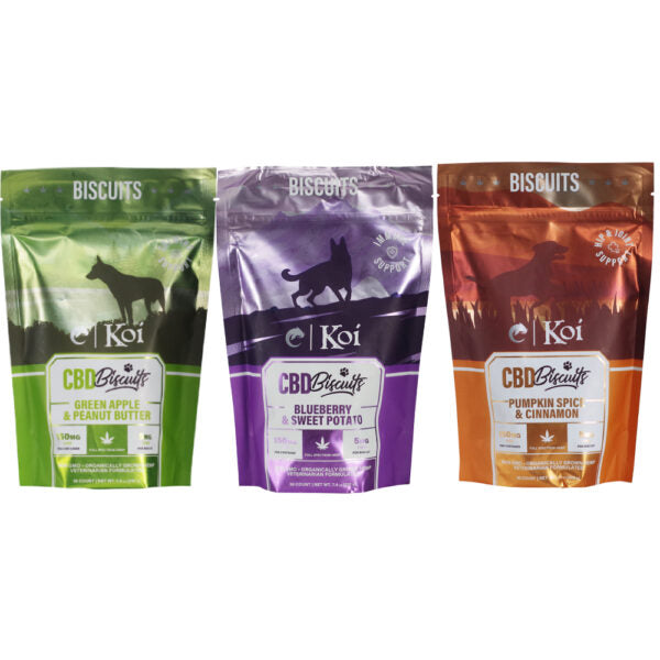 Three stand-up pouches of Koi Biscuits CBD Biscuits dog treats shown side by side on a white background. The left pouch is green and labeled Green Apple & Peanut Butter, the middle is purple and labeled Blueberry & Sweet Potato, and the right is orange-brown and labeled Pumpkin Spice & Cinnamon.