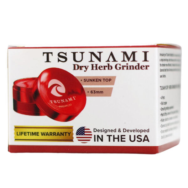 Tsunami Dry Herb Grinder product box, featuring a white background with red borders, a red grinder illustration, and text including 'TSUNAMI Dry Herb Grinder', 'Sunken Top', and 'Designed & Developed in the USA'.