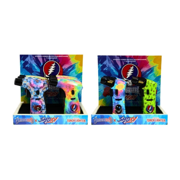 Two Grateful Dead x Sockz touch lighters displayed in their retail packaging, featuring vibrant tie-dye and neon green designs with the Grateful Dead lightning bolt logo.