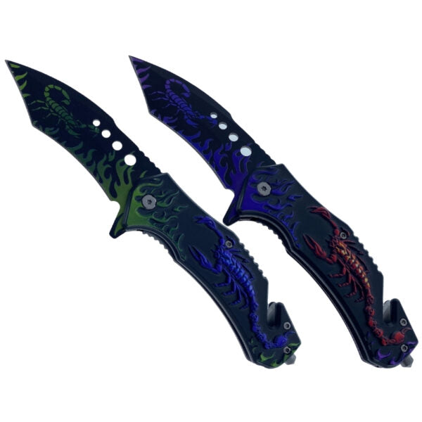 Two folding pocket knives with scorpion designs, one featuring green and black flames with a green scorpion, and the other featuring blue and black flames with a red scorpion, set against a plain white background.